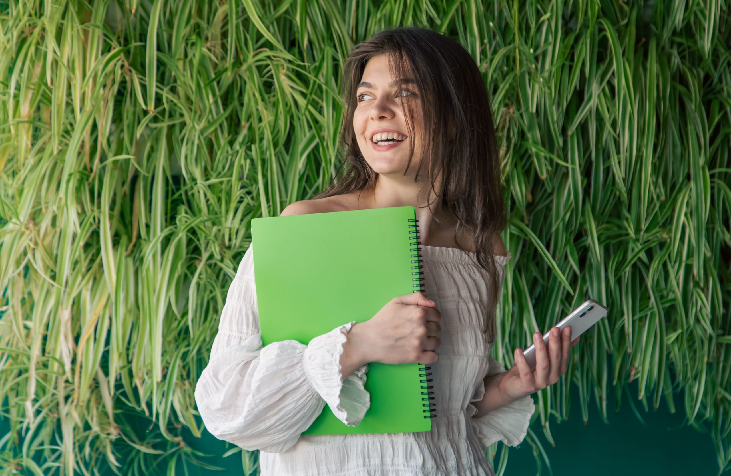 business-young-woman-with-folder-background-green-plants (1) (1)